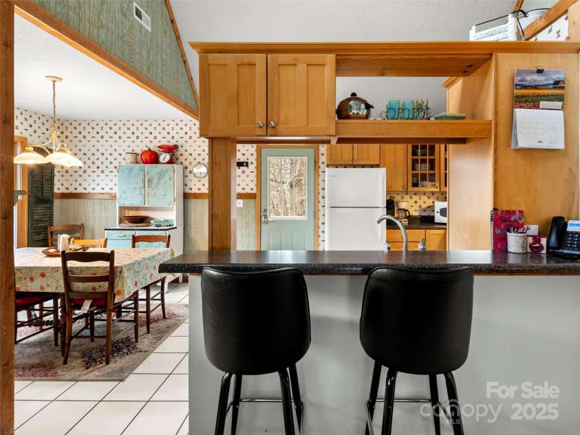 376 Ox Creek Road, Weaverville, NC 28787.  MLS# CAR4241579, YatesRealty ID 7011. Main level kitchen and dining