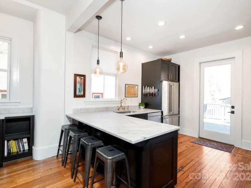 22 Broad Street, Asheville, NC 28801.  MLS# CAR4232987, YatesRealty ID 7019. Chef'a Kitchen Features Marble Countertops and Back Deck Access