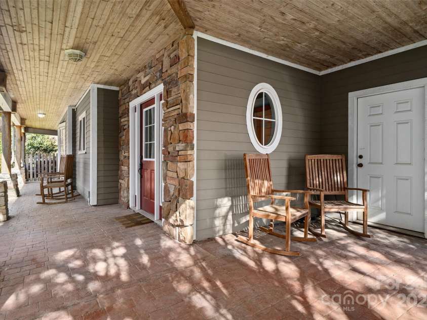 571 Terrys Gap Road, Fletcher, NC 28732.  MLS# CAR4330724, YatesRealty ID 702. Covered front rocking chair porch
