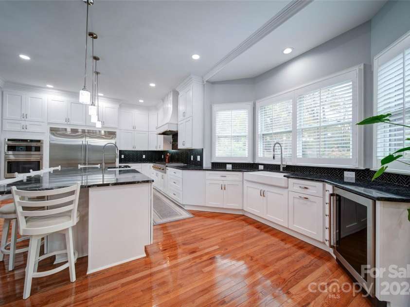 119 Plantation Drive, Mooresville, NC 28117.  MLS# CAR4198986, YatesRealty ID 7020. Island is close to 10' Long.  Notice 2 Barn Sinks with Commercial Like Faucets.