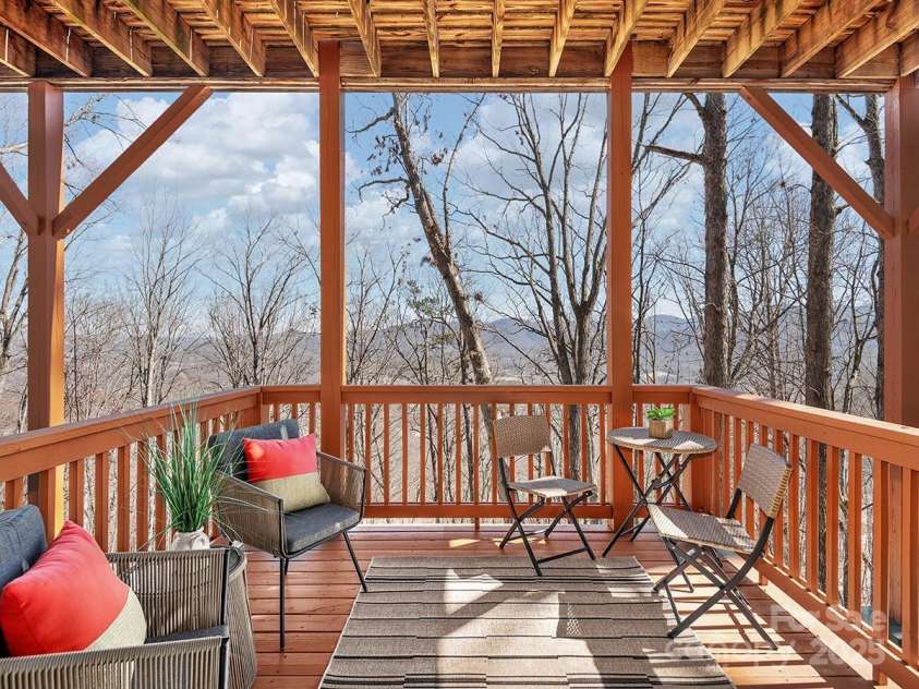 72 Wildflower Mountain Trail, Candler, NC 28715.  MLS# CAR4216852, YatesRealty ID 7043. Cozy lower-level deck takes in incredible mountain views