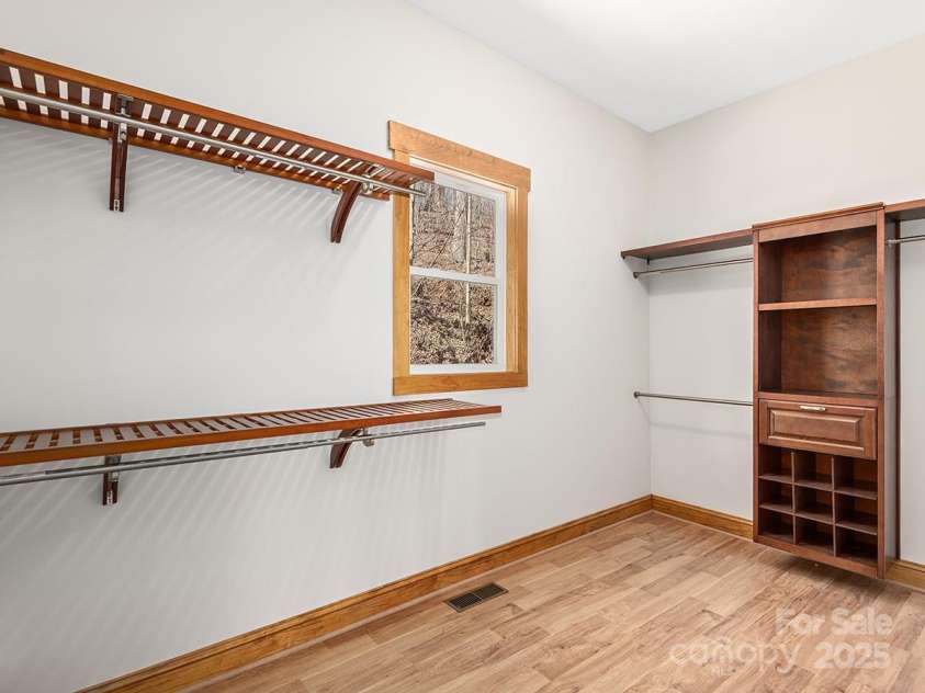 72 Wildflower Mountain Trail, Candler, NC 28715.  MLS# CAR4216852, YatesRealty ID 7043. Dream walk-in closet off primary suite with built in storage