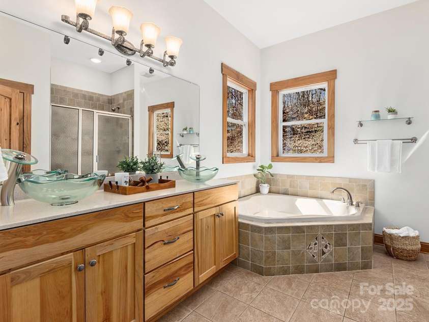 72 Wildflower Mountain Trail, Candler, NC 28715.  MLS# CAR4313051, YatesRealty ID 7043. Wind Down In The Spacious And Spa-Like Primary Bathroom With Dual Vanity And Soaking Tub