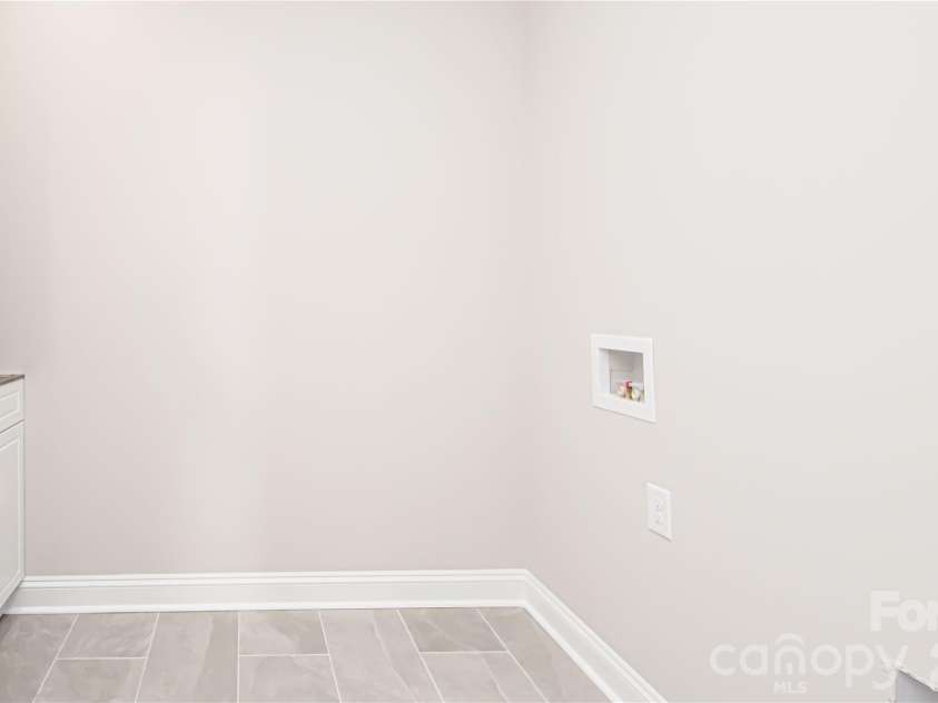 1508 Marion Street, Monroe, NC 28112.  MLS# CAR4315916, YatesRealty ID 7050. Laundry room is located on the main level and features tile flooring and a utility sink.