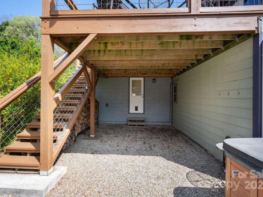 244 Bear Creek Road, Asheville, NC 28806.  MLS# CAR4243521, YatesRealty ID 7055. Door to Finished Basement * Hot Tub Patio