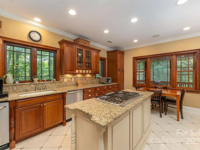 168 Chattooga Run, Hendersonville, NC 28739.  MLS# CAR4250934, YatesRealty ID 706. A perfect blend of granite and rich wood trim for a kitchen that exudes style