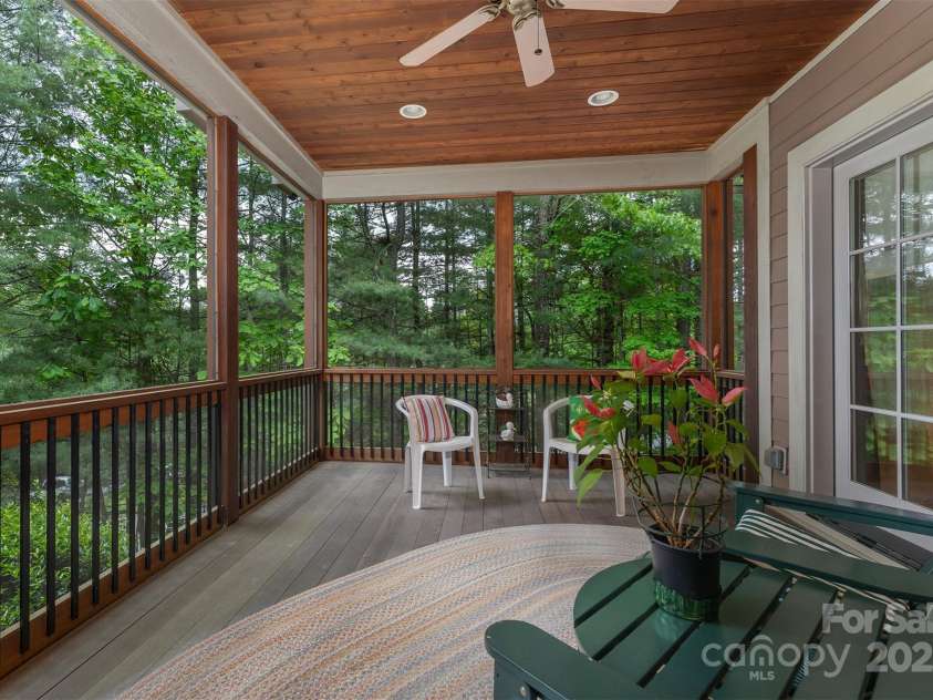 168 Chattooga Run, Hendersonville, NC 28739.  MLS# CAR4250934, YatesRealty ID 706. Charming covered porch with a 9-foot ceiling and a warm gas fireplace.