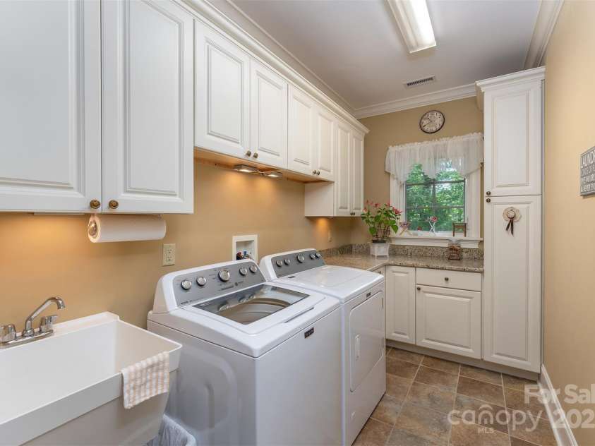 168 Chattooga Run, Hendersonville, NC 28739.  MLS# CAR4250934, YatesRealty ID 706. Convenient main-level laundry with built-ins and a sink