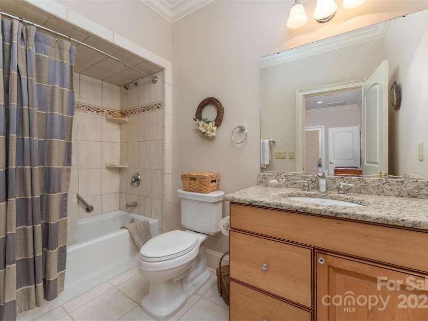 168 Chattooga Run, Hendersonville, NC 28739.  MLS# CAR4250934, YatesRealty ID 706. Guest ensuite bath featuring elegant tile and granite finishes