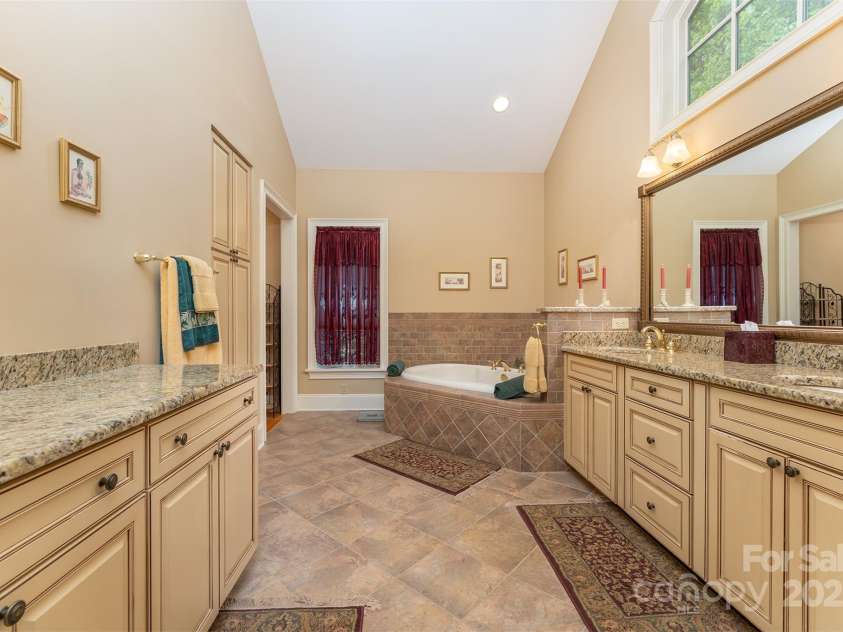 168 Chattooga Run, Hendersonville, NC 28739.  MLS# CAR4250934, YatesRealty ID 706. Primary bath features a luxurious open layout with plenty of natural light from large windows.