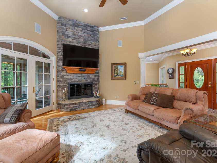 168 Chattooga Run, Hendersonville, NC 28739.  MLS# CAR4250934, YatesRealty ID 706. Spacious great room boasts 13-ft ceilings and a warm gas fireplace centerpiece.