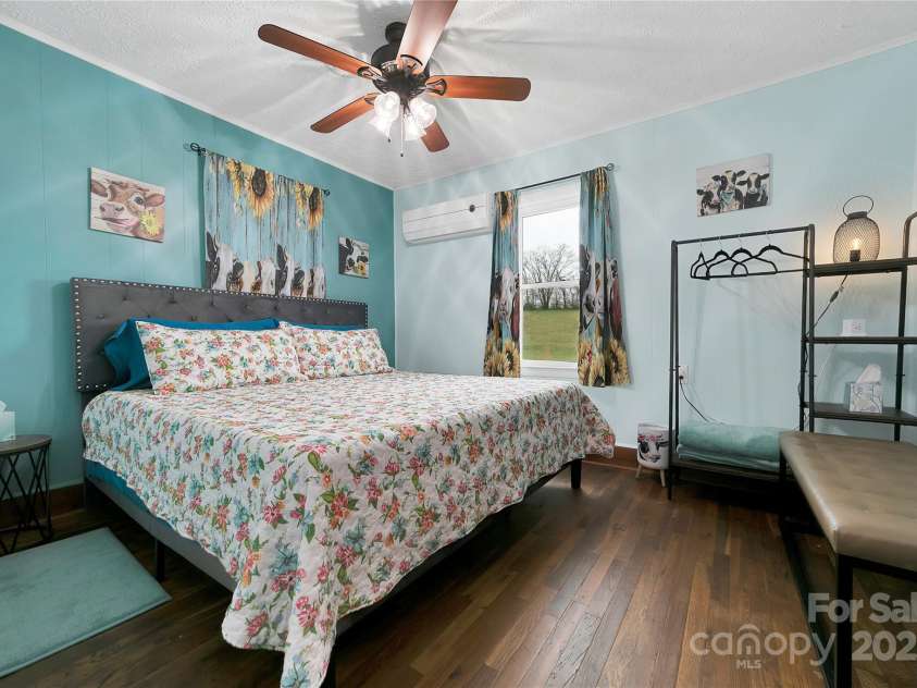 626 Fairview Loop, Hot Springs, NC 28743.  MLS# CAR4302454, YatesRealty ID 706. The front bedroom suite boasts its king bed with plenty of space to move around. The entire suite is adorned with adorable heifers at every turn!