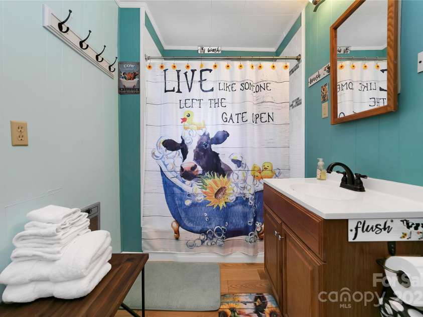 626 Fairview Loop, Hot Springs, NC 28743.  MLS# CAR4302454, YatesRealty ID 706. The front bedroom suites' bathroom is also adorned with adorable heifers at every turn!