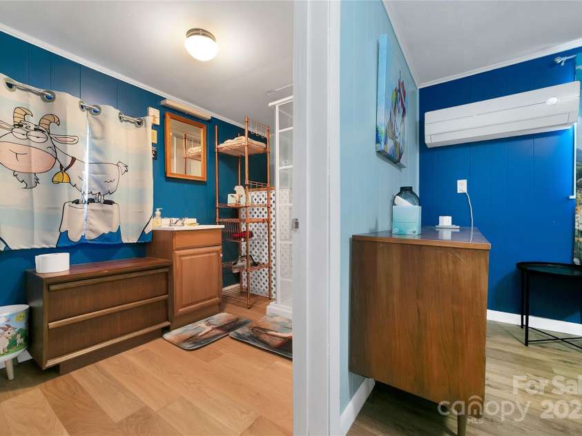 626 Fairview Loop, Hot Springs, NC 28743.  MLS# CAR4302454, YatesRealty ID 706. The rear bedroom suite has its own large roomy bathroom with plenty of space to move around in. Also adorned with cute goats at every turn!