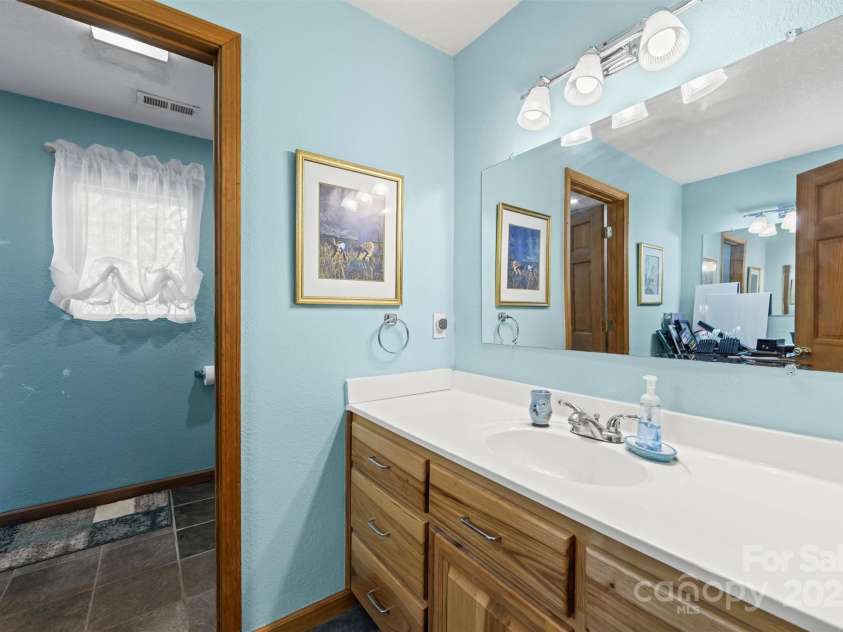 336 Berry Lane, Bryson City, NC 28713.  MLS# CAR4313303, YatesRealty ID 708. Bathroom has vanity on each side