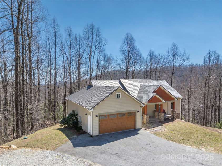 6753 Pinnacle Mountain Road, Zirconia, NC 28790.  MLS# CAR4237345, YatesRealty ID 7098. Front View of House with mountains in the background.