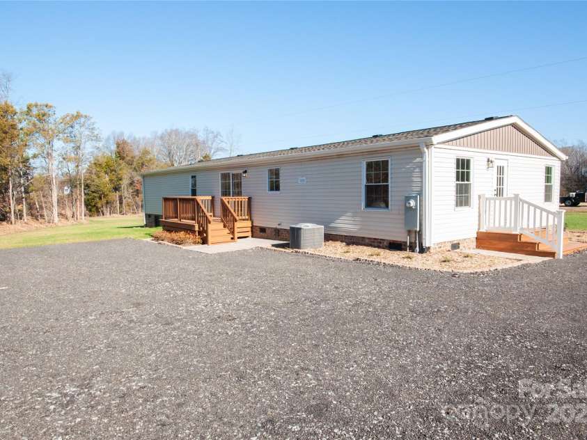 816 Perry Road, Troutman, NC 28166.  MLS# CAR4210141, YatesRealty ID 710. Back of house showing parking