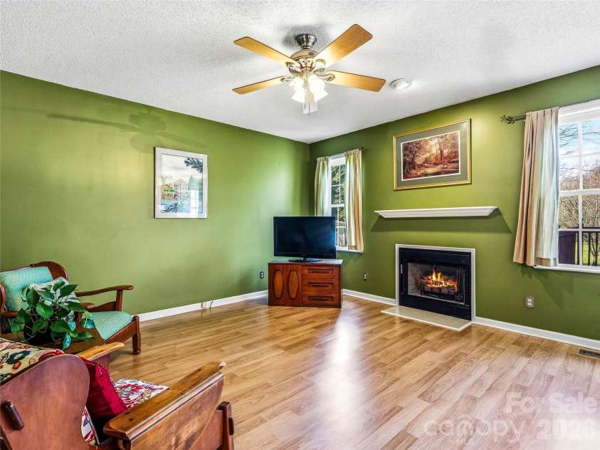 61 Rolling Hills Road, Mills River, NC 28759.  MLS# CAR4355749, YatesRealty ID 7110. Cozy family room with gas firplace.