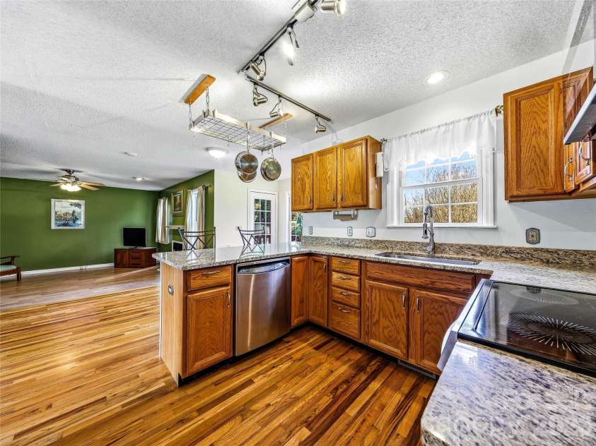 61 Rolling Hills Road, Mills River, NC 28759.  MLS# CAR4355749, YatesRealty ID 7110. Kitchen opens up to family room and back deck.