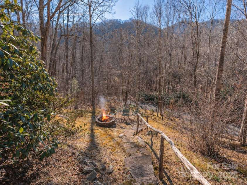 220 George Sutton Road, Waynesville, NC 28785.  MLS# CAR4330398, YatesRealty ID 712. Fire shown is for promotional purposes only.