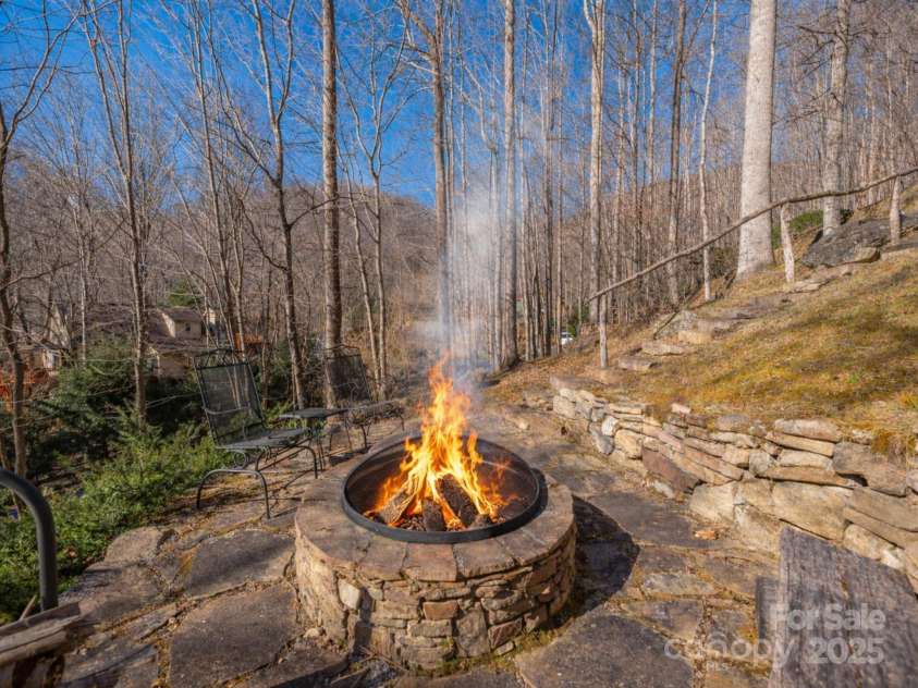 220 George Sutton Road, Waynesville, NC 28785.  MLS# CAR4330398, YatesRealty ID 712. Fire shown is for promotional purposes only.