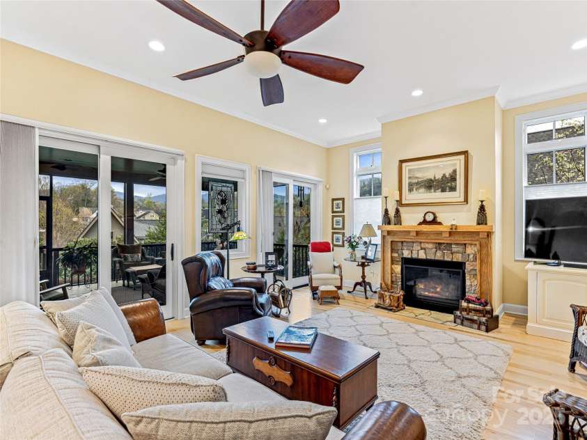 38 Chantilly Drive, Asheville, NC 28804.  MLS# CAR4245606, YatesRealty ID 7126. Living room opening to screened porch