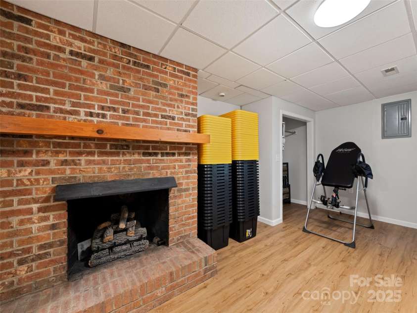 263 Blanton Street, Columbus, NC 28722.  MLS# CAR4190973, YatesRealty ID 7130. Downstairs Fireplace Room