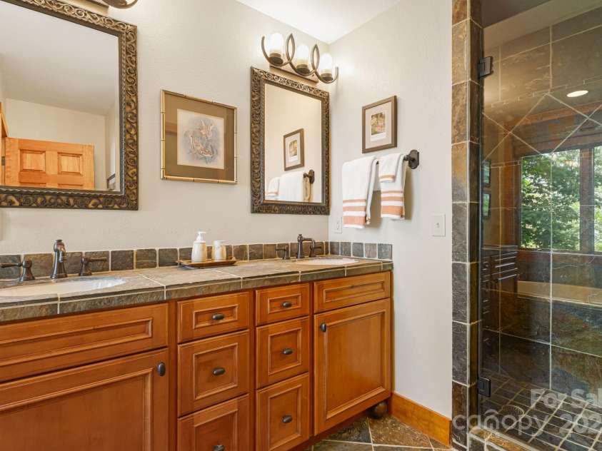 197 Cherry Knob Drive, Mars Hill, NC 28754.  MLS# CAR4271284, YatesRealty ID 7144. Slate tile accents and dual vanities create a luxurious en suite bath experience.