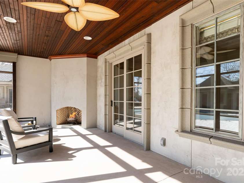 316 Braeside Court, Asheville, NC 28803.  MLS# CAR4198099, YatesRealty ID 7157. Covered screened porch with fireplace off of the Owners Wing just steps to the Hot tub and pool 