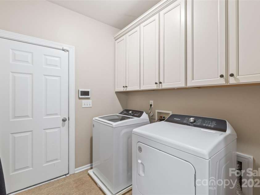 8905 Valleymoon Lane, Charlotte, NC 28214.  MLS# CAR4199406, YatesRealty ID 7165. Large laundry with entrance to 3 car garage