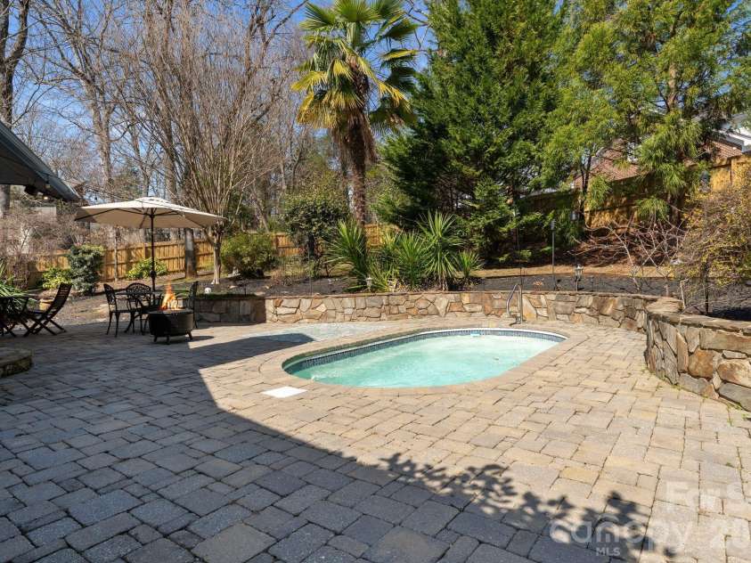 1432 Jules Court, Charlotte, NC 28226.  MLS# CAR4355299, YatesRealty ID 7181. Pool and expansive paved patio