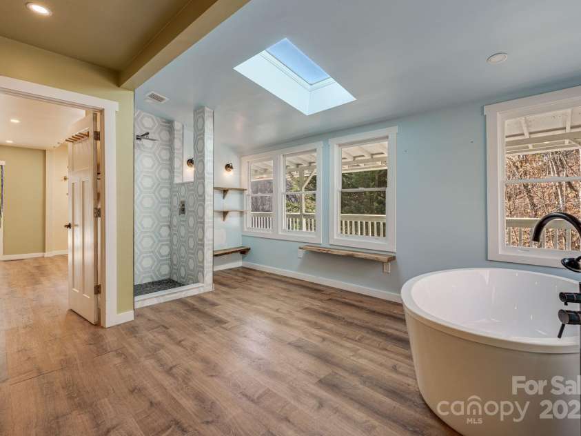 340 Wendy Avenue, Marshall, NC 28753.  MLS# CAR4210108, YatesRealty ID 7191. Tile shower & soaking tub with great light via skylight and large windows