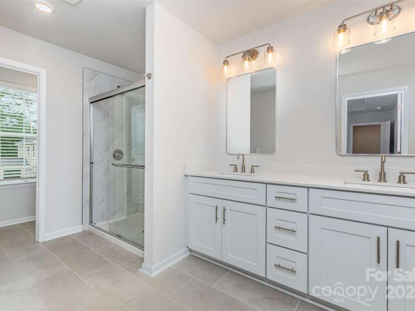 2039 Sadler Woods Lane, Charlotte, NC 28214.  MLS# CAR4265579, YatesRealty ID 721. Primary bathroom w/ double vanity. Representational Photo.