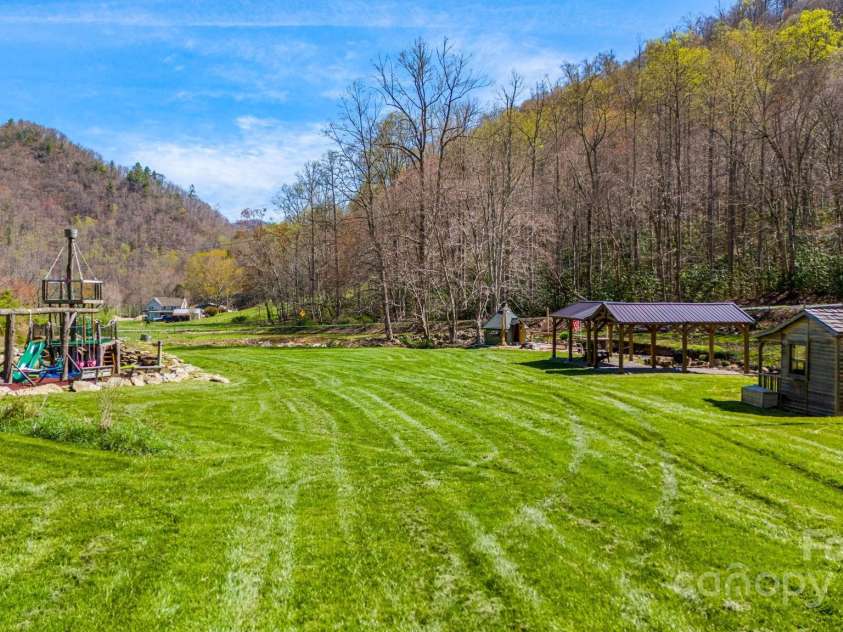 85 Woody Farm Road, Hot Springs, NC 28743.  MLS# CAR4248089, YatesRealty ID 7213. Creekside pasture with pavilion, playground, BBQ hut