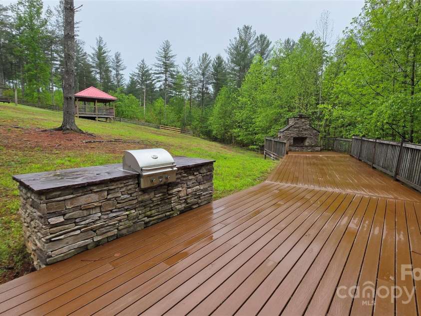3381 Peninsula Pointe Drive, Valdese, NC 28690.  MLS# CAR4249000, YatesRealty ID 7236. Grill, Fire pit and stone fireplace at Lakeside park