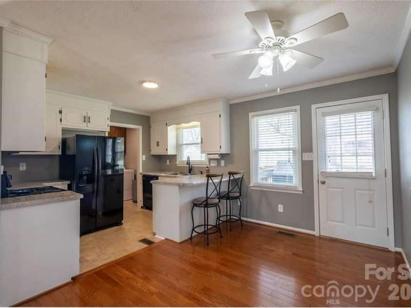 102 Wendover Drive, Lincolnton, NC 28092.  MLS# CAR4352261, YatesRealty ID 7238. Dining and kitchen, door to backyard deck