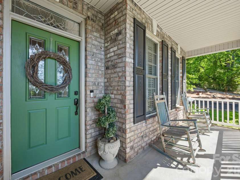244 Mark Ryan Lane, Dallas, NC 28034.  MLS# CAR4389974, YatesRealty ID 725. Covered front porch with sitting area
