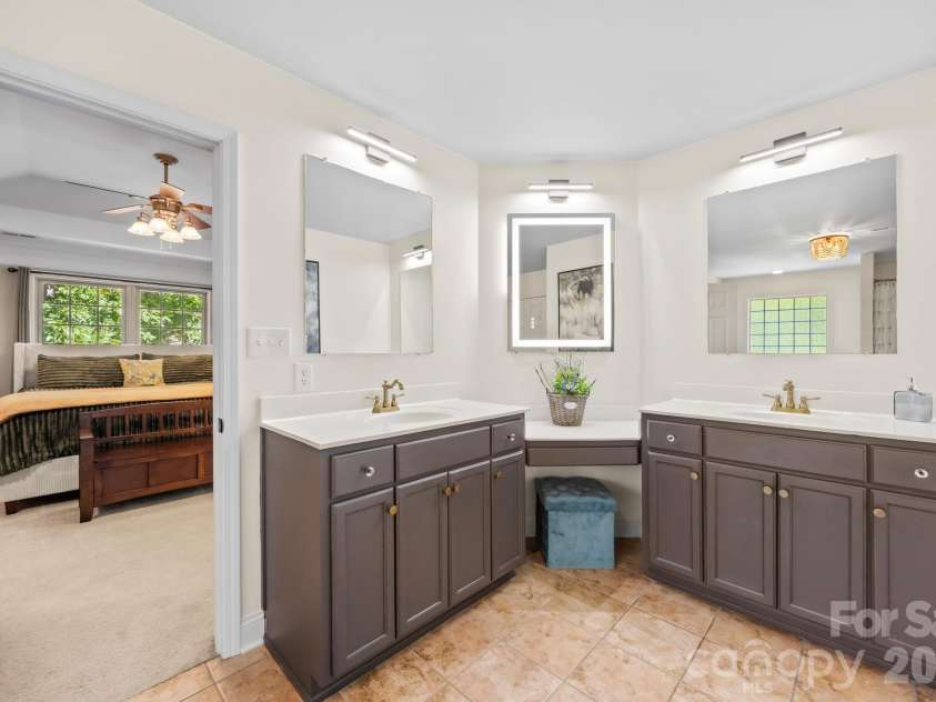 244 Mark Ryan Lane, Dallas, NC 28034.  MLS# CAR4389974, YatesRealty ID 725. Dual vanity with sitting area and touch screen backlit mirror