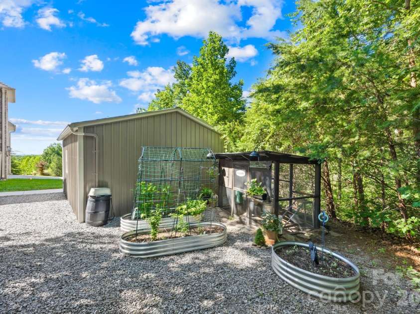 244 Mark Ryan Lane, Dallas, NC 28034.  MLS# CAR4389974, YatesRealty ID 725. Metal planter boxes, rain barrel