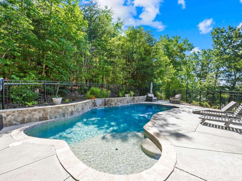 244 Mark Ryan Lane, Dallas, NC 28034.  MLS# CAR4389974, YatesRealty ID 725. Pebble Crete, travertine coping and water features.