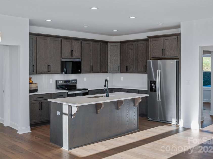 53 McKinley Drive, Hendersonville, NC 28792.  MLS# CAR4197454, YatesRealty ID 7263. The attractive kitchen features a large island, stainless appliances, abundant storage, and tasteful finishes.