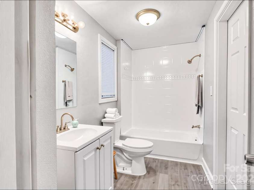 4229 Plato Circle, Charlotte, NC 28208.  MLS# CAR4303896, YatesRealty ID 7273. Full bathroom which is connected to both the primary bedroom and laundry area (virtually staged).