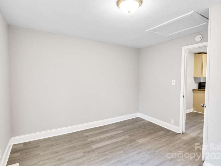 4229 Plato Circle, Charlotte, NC 28208.  MLS# CAR4303896, YatesRealty ID 7273. Primary bedroom, facing entry connected to kitchen.