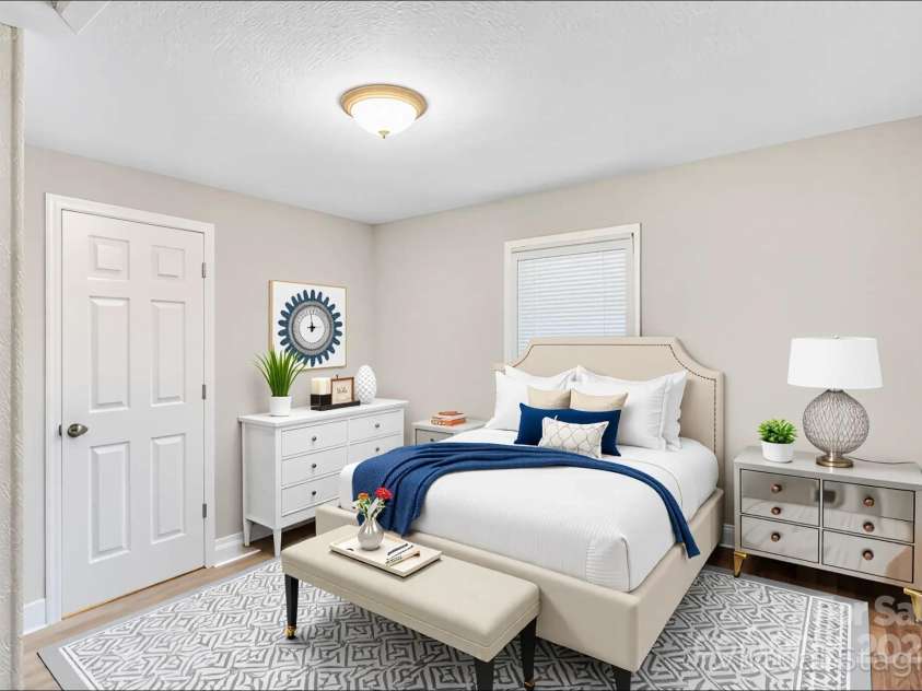4229 Plato Circle, Charlotte, NC 28208.  MLS# CAR4303896, YatesRealty ID 7273. Walking into primary bedroom from kitchen. Closed door opens to full bath. Full bath is also accessible from laundry area. (Photo is virtually staged).