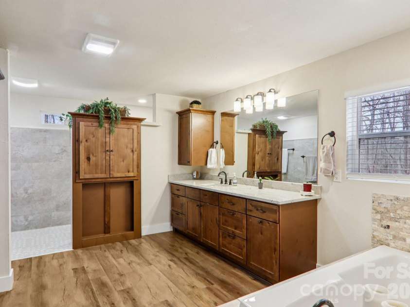 159 Broken Bow Run, Pickens, SC 29671.  MLS# CAR4355826, YatesRealty ID 7277. Luxurious primary bath with oversized tiled shower, separate soaking tub, and double vanity.