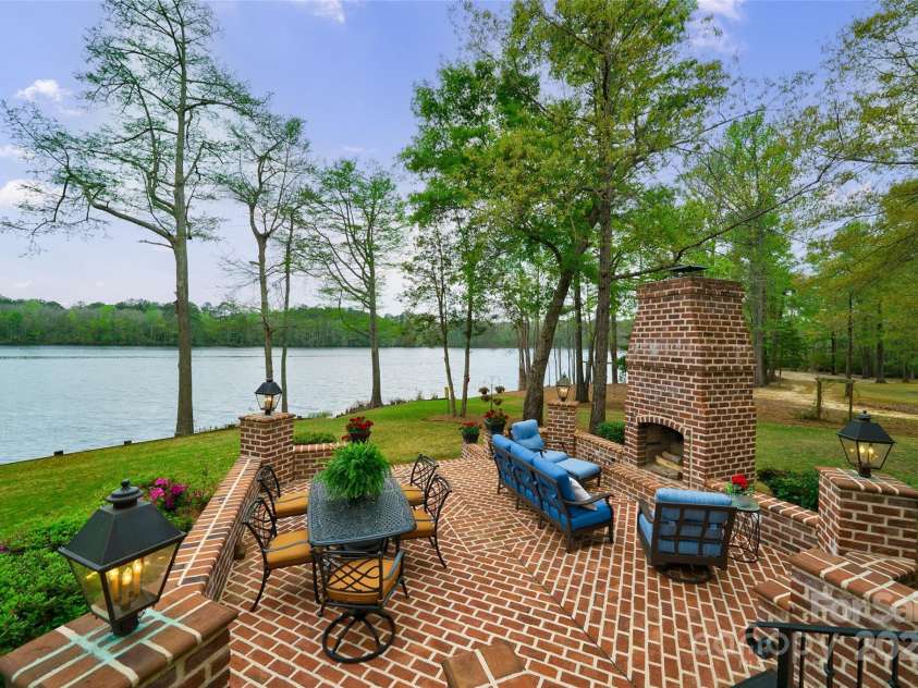 229 Joseph Kershaw Road, Eastover, SC 29044.  MLS# CAR4122309, YatesRealty ID 7302. A full brick patio with wood burning fireplace & custom copper lanterns
