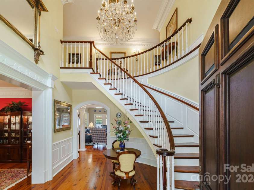 229 Joseph Kershaw Road, Eastover, SC 29044.  MLS# CAR4122309, YatesRealty ID 7302. French Chandelier and Curved Staircase, pine floors cut from timber off property throughout the majority of the home, extensive custom designed and cut trim work