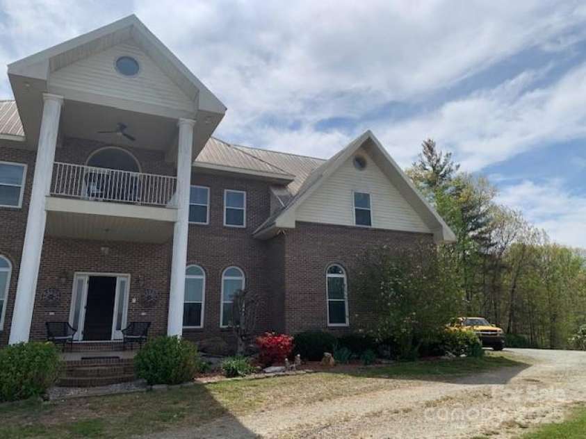 2399 PLEASANT GROVE Road, Hendersonville, NC 28739.  MLS# CAR4247893, YatesRealty ID 7314. Rounding corner to pond, side deck entry