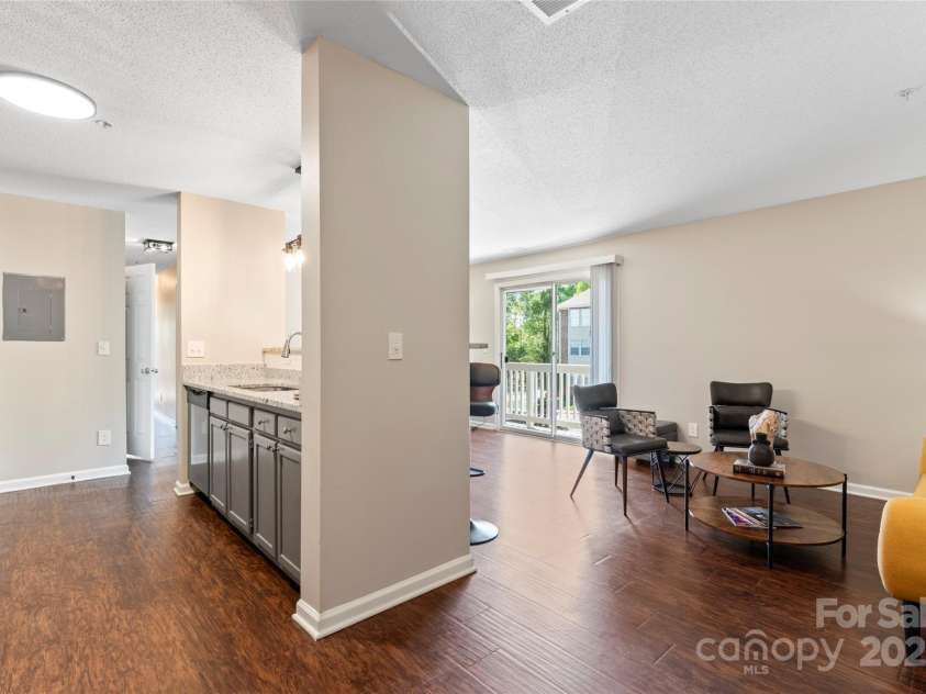 1620#F Arlyn Circle, Charlotte, NC 28213.  MLS# CAR4246653, YatesRealty ID 7325. Kitchen has new granite countertop and large oversized stainless steel sink.  Bar counter overlooks living and dining areas.