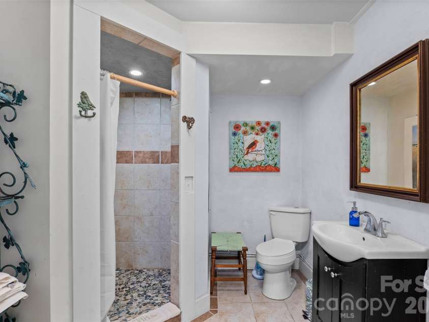 1087 Turkey Creek Road, Leicester, NC 28748.  MLS# CAR4358676, YatesRealty ID 7371. Lower level full bathroom with tiled shower